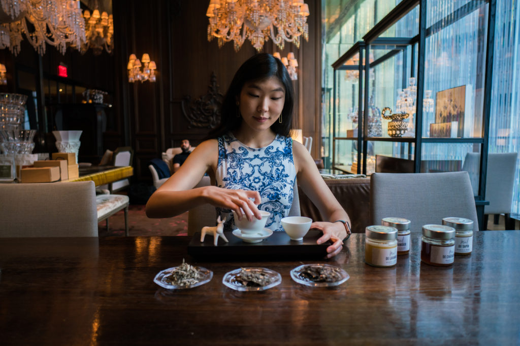 Ashley Lim, Founder of Mansa Tea, brewing aged tea with a handmade crackle gaiwan.